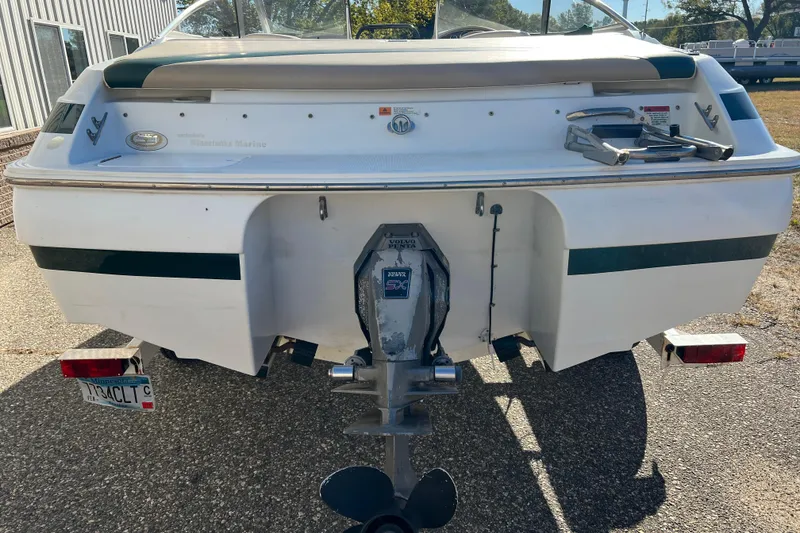 Slide: The Image of 1999 Chris-Craft 190 Bowrider boat rear view with outboard motor and trailer. - 5