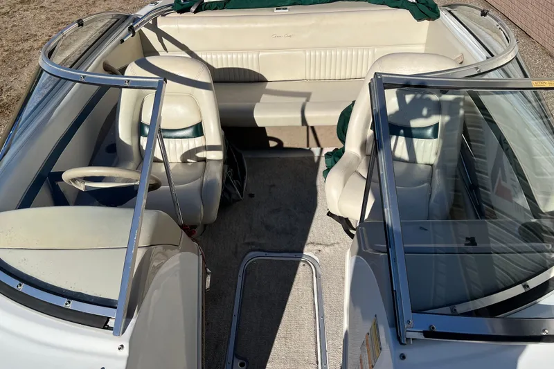 Slide: The Image of 1999 Chris-Craft 190 Bowrider interior with white seats and steering wheel. - 8