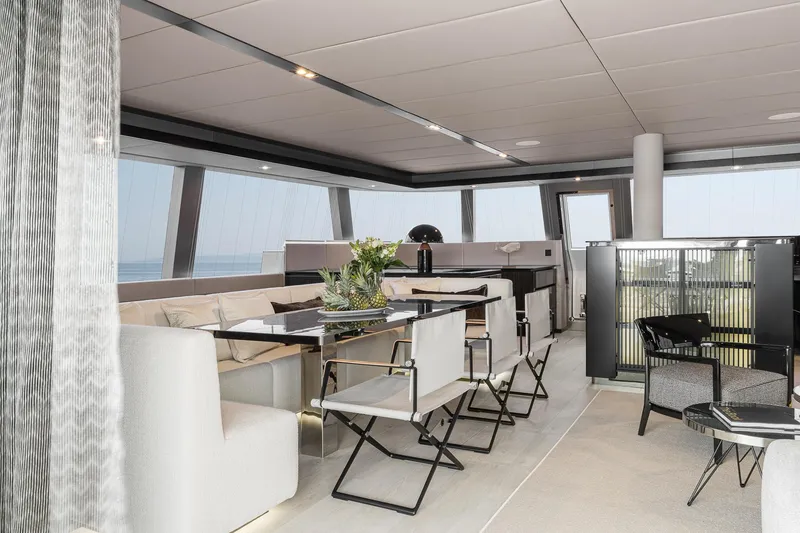 Slide: The Image of Luxurious interior of 2026 Sunreef 70 yacht with modern dining area and panoramic windows. - 13