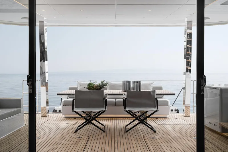 Slide: The Image of Luxurious Sunreef 70 yacht deck with modern seating, overlooking serene ocean view, 2026 model. - 4