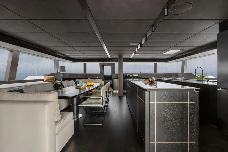 Slide: The Image of Luxurious interior of 2026 Sunreef 70 yacht with modern dining and kitchen area. - 5