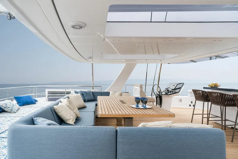 Slide: The Image of Luxurious Sunreef 80 yacht deck with seating, dining area, and ocean view, 2026 model. - 7
