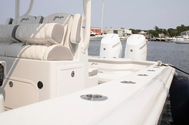 Slide: The Image of 2025 Yellowfin 32 Offshore boat with dual Mercury engines docked at marina. - 17
