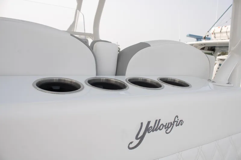 Slide: The Image of 2025 Yellowfin 32 Offshore boat interior with cup holders and logo detail. - 21
