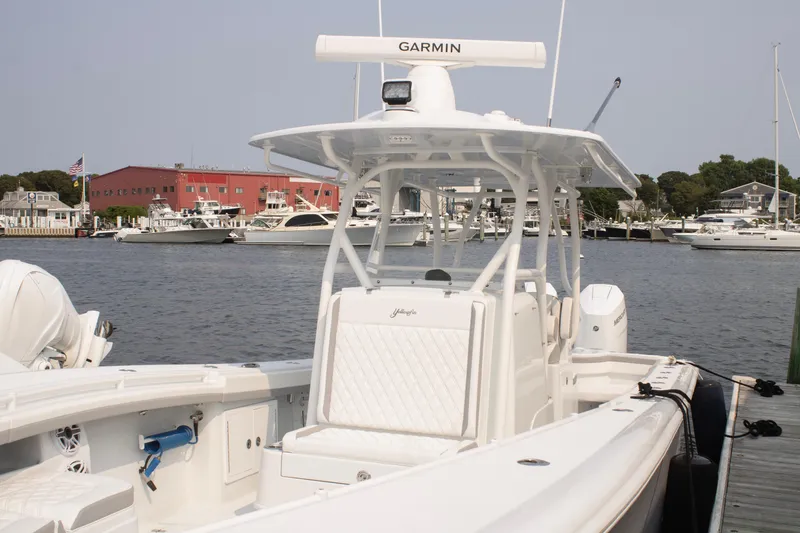 Slide: The Image of 2025 Yellowfin 32 Offshore boat docked at marina with Garmin equipment. - 27