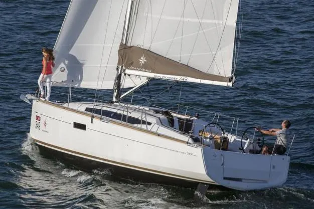 The Image of 2018 Jeanneau Sun Odyssey 349 sailboat docked at marina under blue sky. - 0