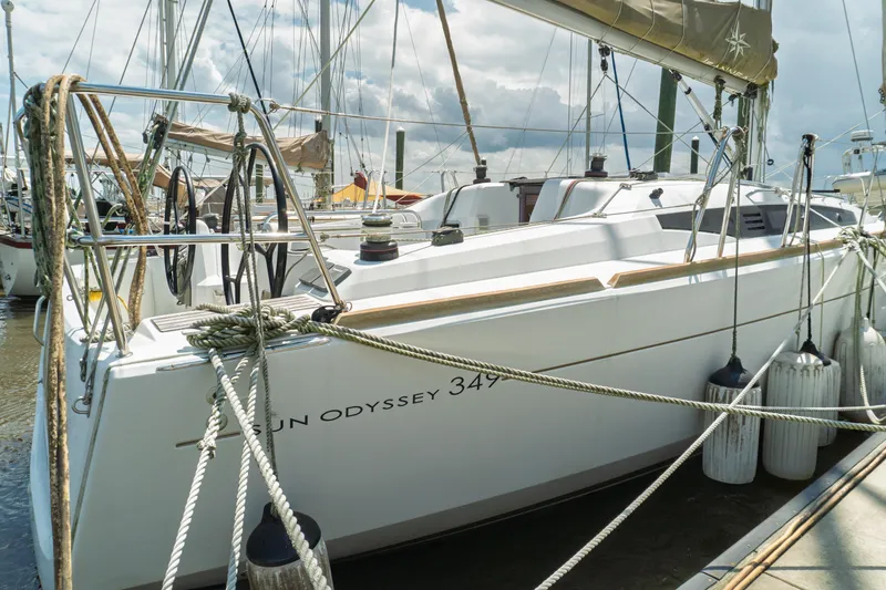 Slide: The Image of 2018 Jeanneau Sun Odyssey 349 sailboat deck with ropes and seating at marina. - 10