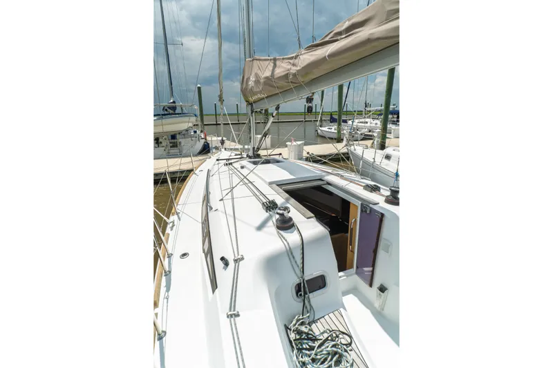 Slide: The Image of Interior of 2018 Jeanneau Sun Odyssey 349 sailboat, featuring modern seating and kitchenette. - 27
