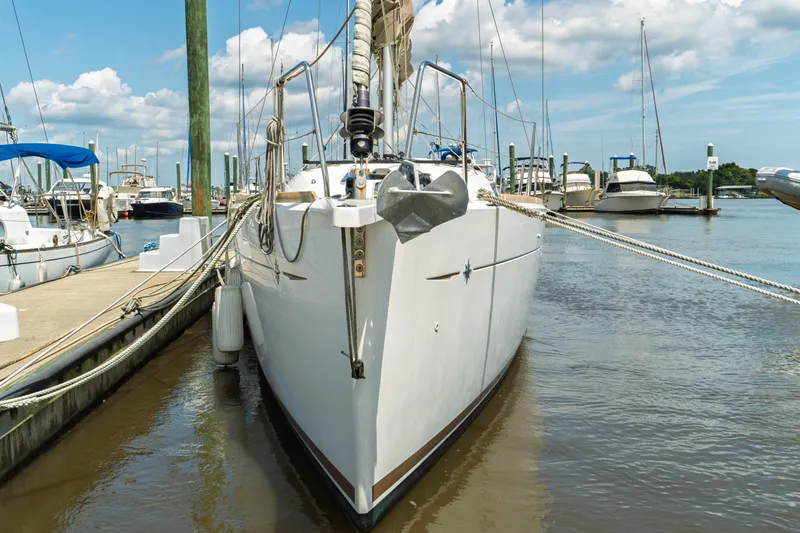 Slide: The Image of 2018 Jeanneau Sun Odyssey 349 sailboat docked at marina, clear sky background. - 4