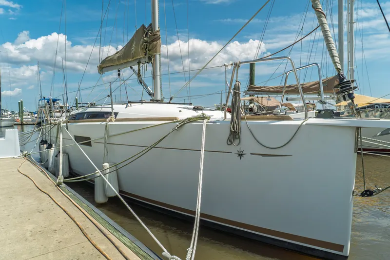 Slide: The Image of 2018 Jeanneau Sun Odyssey 349 yacht cockpit with ropes and seating, docked at marina. - 7