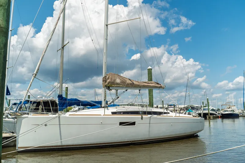 Slide: The Image of 2018 Jeanneau Sun Odyssey 349 sailboat cockpit with dual steering wheels, docked at marina. - 8