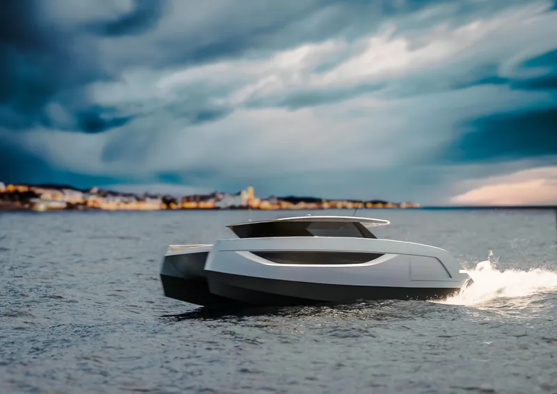 Slide: The Image of Futuristic Sunreef 44 Ultima yacht cruising on open water under dramatic sky, 2026 model. - 4