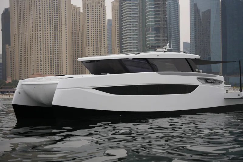 The Image of 2026 Sunreef 55 Ultima yacht in urban waterfront setting with skyscrapers. - 0