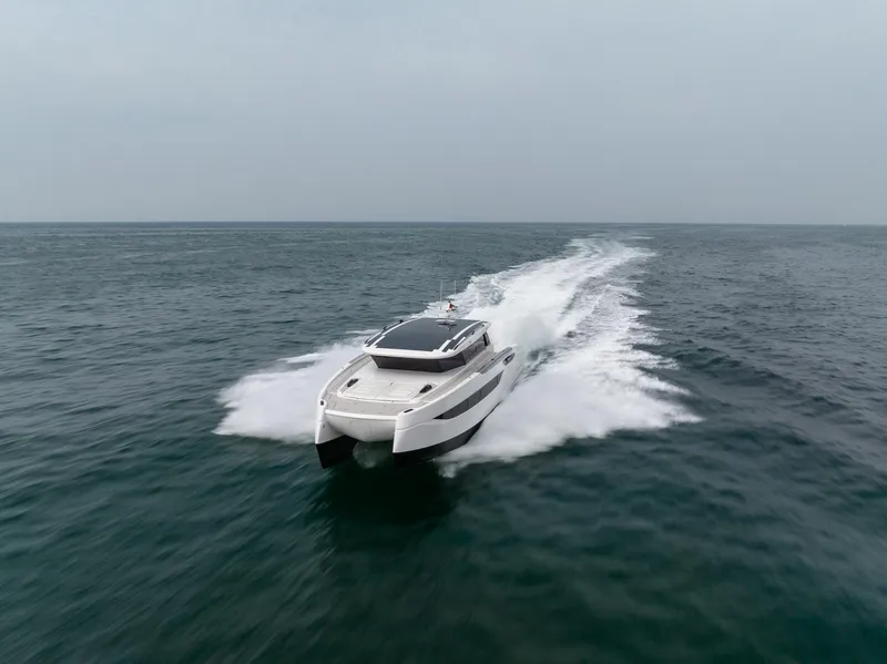 Slide: The Image of 2026 Sunreef 55 Ultima yacht cruising on open sea, showcasing sleek design and speed. - 18