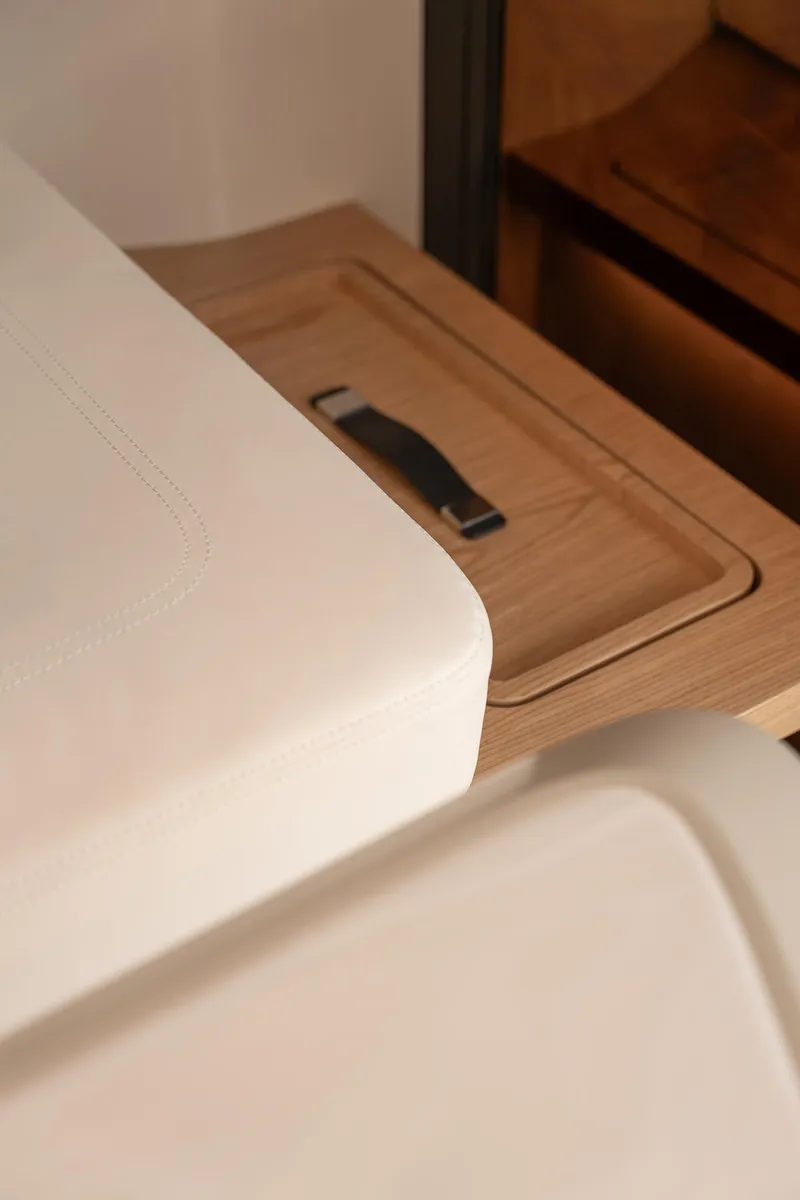 Slide: The Image of Interior detail of 2026 Sunreef 55 Ultima yacht, featuring sleek wood and leather design elements. - 7