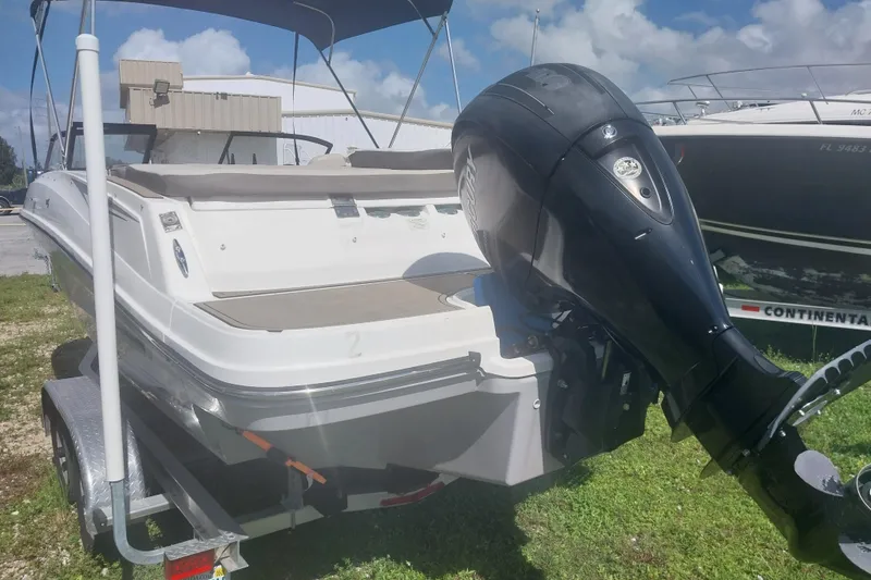 Slide: The Image of 2017 Bayliner VR5 Bowrider OB on trailer, featuring outboard motor, parked outdoors. - 2