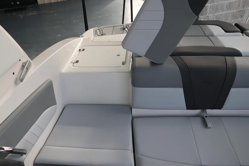 Slide: The Image of 2026 Chaparral 21 SSi OB boat interior with gray and white seating and storage compartment. - 11
