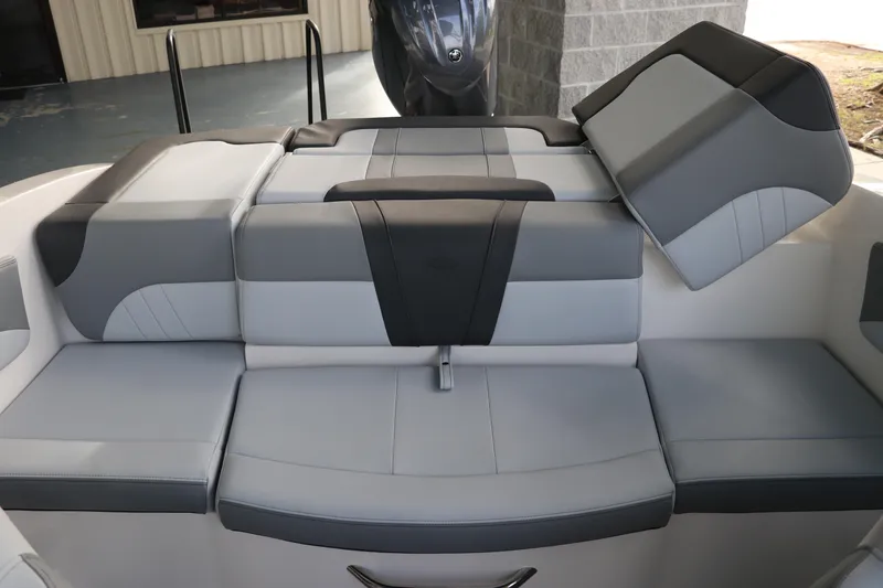 Slide: The Image of 2026 Chaparral 21 SSi OB boat interior with gray and black cushioned seating. - 13