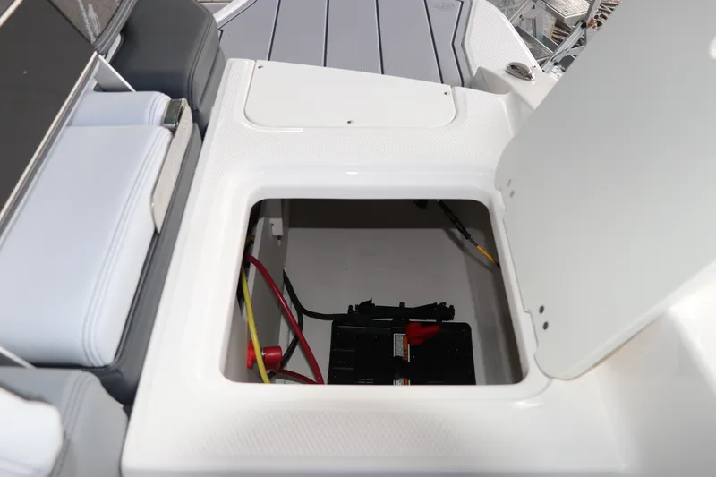 Slide: The Image of Storage compartment in 2026 Chaparral 21 SSi OB boat, featuring battery and wiring. - 15