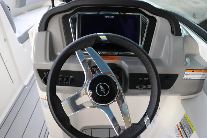 Slide: The Image of Steering wheel and dashboard of 2026 Chaparral 21 SSi OB boat with Simrad display. - 29