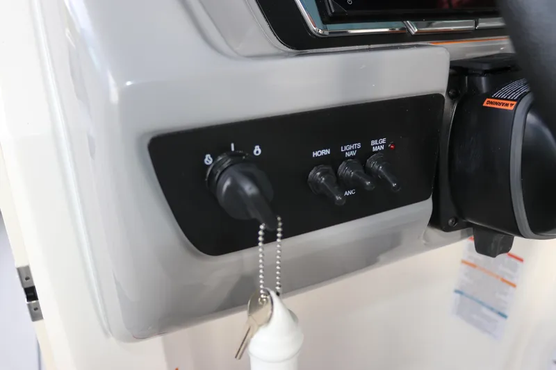 Slide: The Image of Control panel of 2026 Chaparral 21 SSi OB boat with switches and ignition keys. - 30