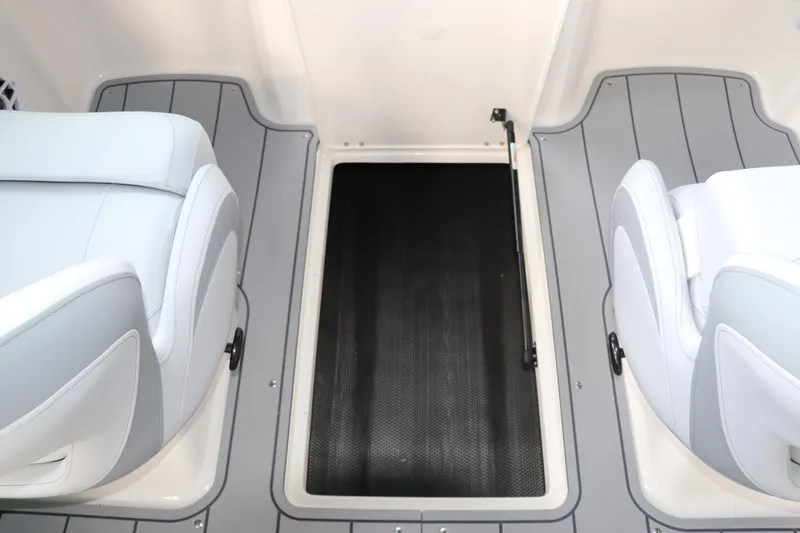 Slide: The Image of 2026 Chaparral 21 SSi OB boat interior with gray seating and storage compartment. - 35