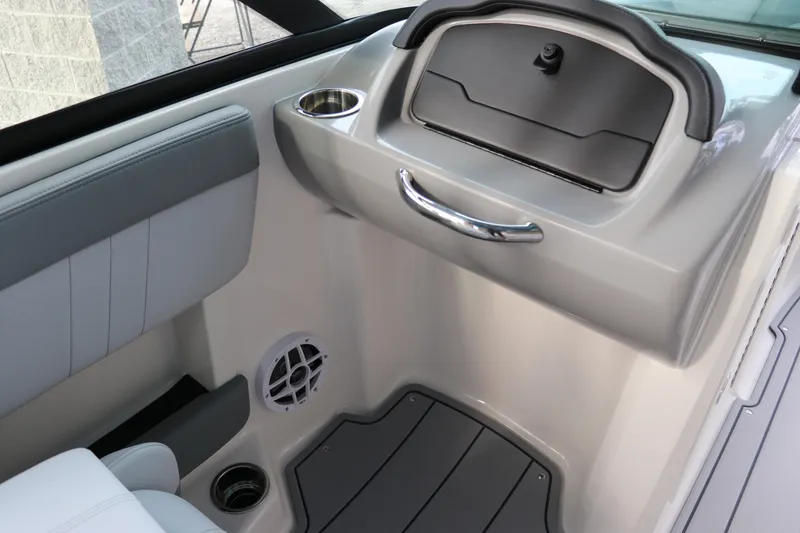 Slide: The Image of Interior of 2026 Chaparral 21 SSi OB boat, featuring storage compartment and cup holder. - 39