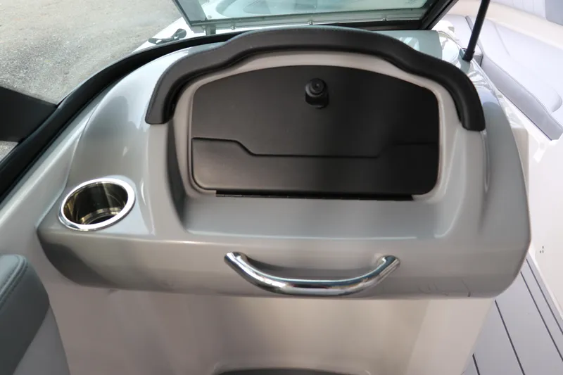 Slide: The Image of 2026 Chaparral 21 SSi OB boat dashboard with storage compartment and cup holder. - 40