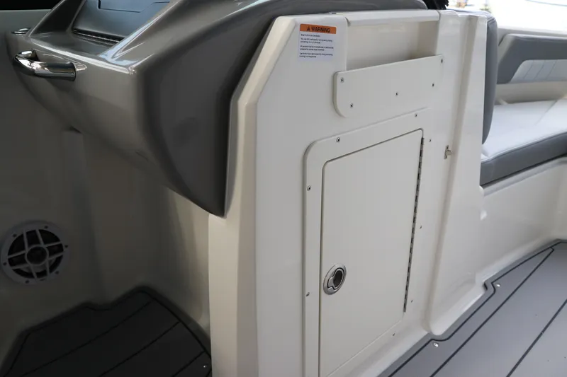 Slide: The Image of 2026 Chaparral 21 SSi OB boat interior, featuring storage compartment and seating area. - 43