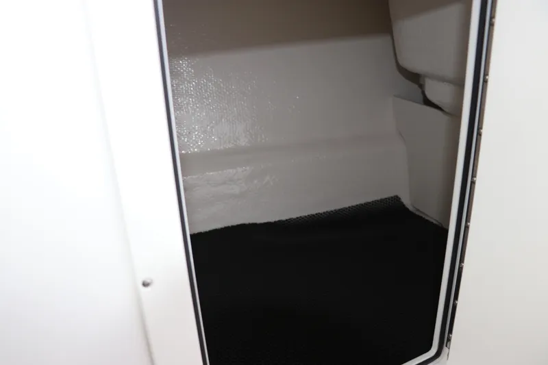 Slide: The Image of Storage compartment inside 2026 Chaparral 21 SSi OB boat, featuring a sleek interior design. - 45