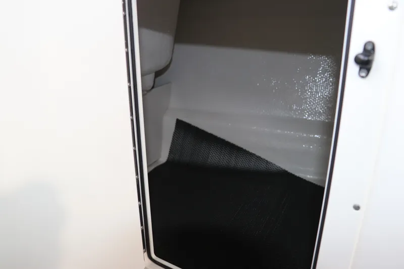 Slide: The Image of Storage compartment inside 2026 Chaparral 21 SSi OB boat, featuring sleek interior design. - 47