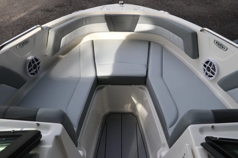 Slide: The Image of 2026 Chaparral 21 SSi OB boat interior with gray seating and speakers. - 48