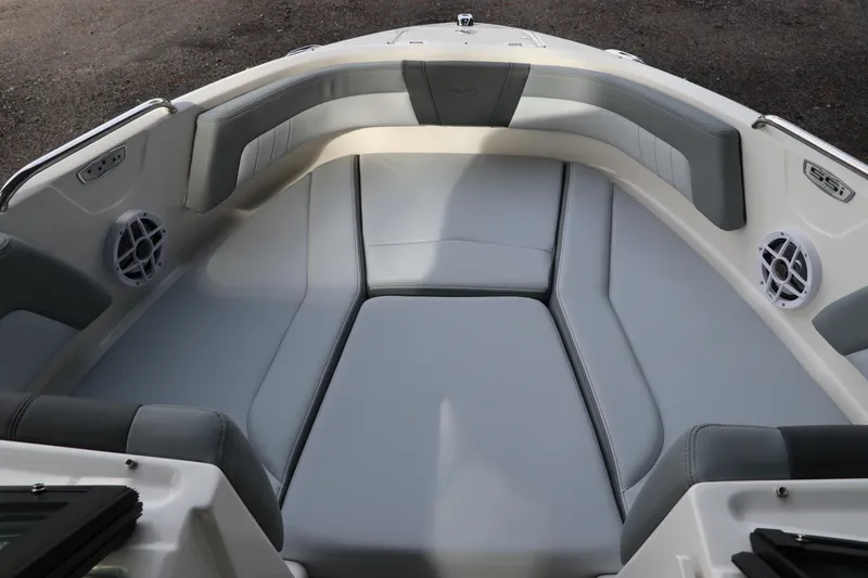 Slide: The Image of 2026 Chaparral 21 SSi OB boat interior with gray cushioned seating and speakers. - 51