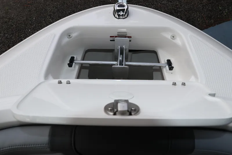 Slide: The Image of 2026 Chaparral 21 SSi OB boat anchor storage compartment, open and empty. - 55