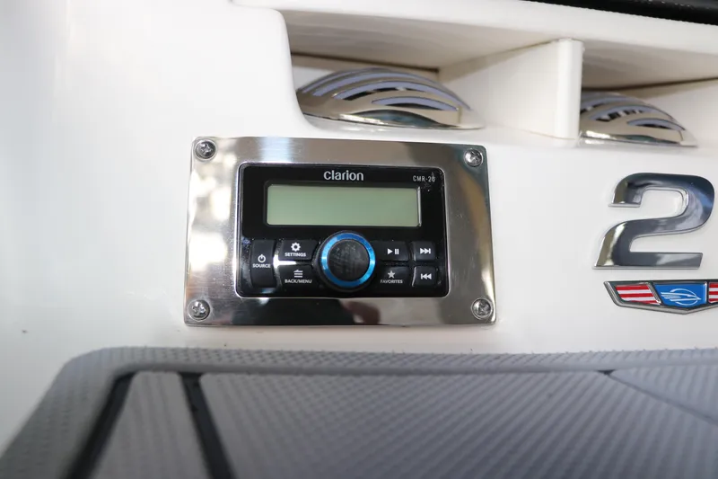 Slide: The Image of Control panel on 2026 Chaparral 21 SSi OB boat, featuring Clarion audio system. - 7
