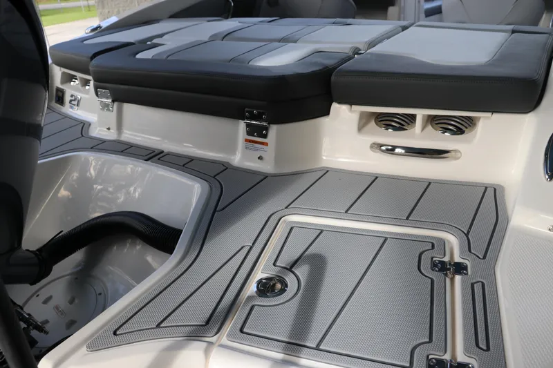 Slide: The Image of 2026 Chaparral 21 SSi OB boat interior with sleek seating and storage compartments. - 8