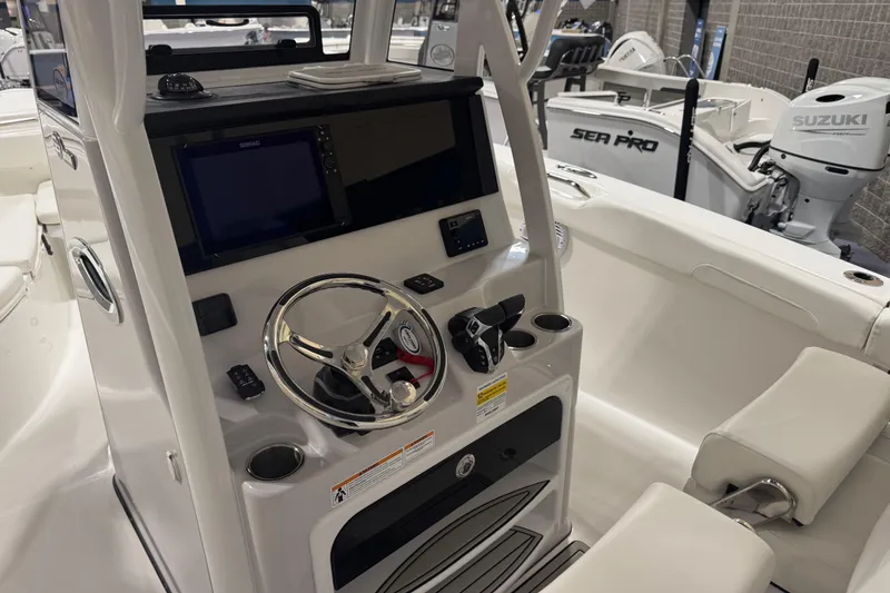 Slide: The Image of 2026 Sea Pro 262 DLX boat interior with steering wheel and control panel. - 3