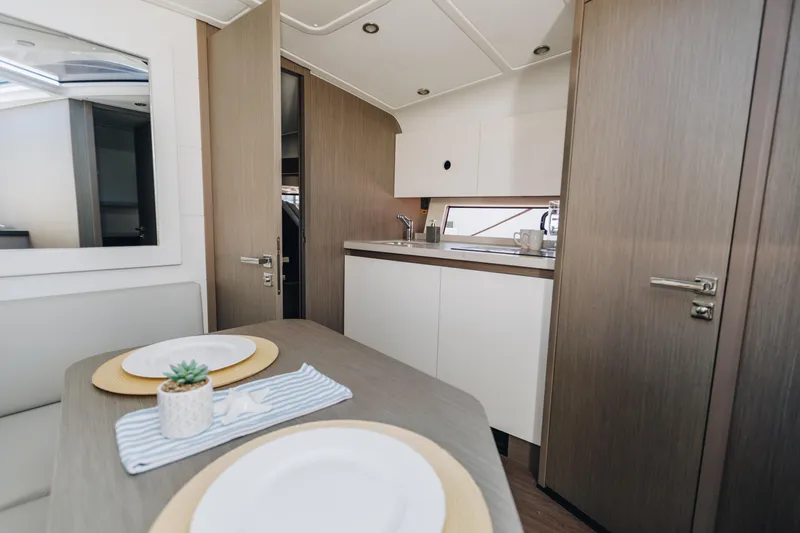 Slide: The Image of Interior of 2023 Beneteau Gran Turismo 41 yacht, featuring modern kitchen and dining area. - 12