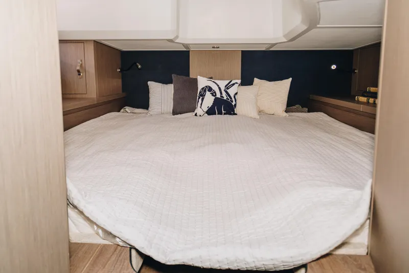 Slide: The Image of 2023 Beneteau Gran Turismo 41 cabin with cozy bedding and decorative pillows. - 13