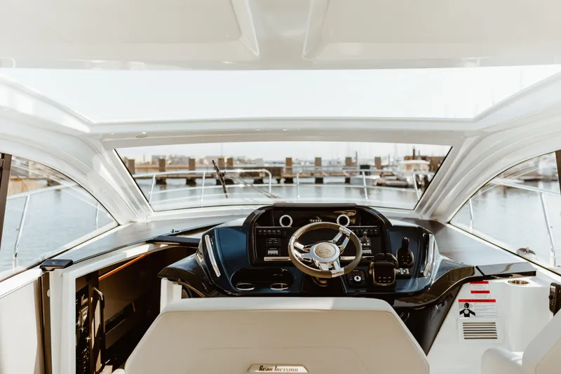 Slide: The Image of 2023 Beneteau Gran Turismo 41 yacht helm with modern controls and marina view. - 6