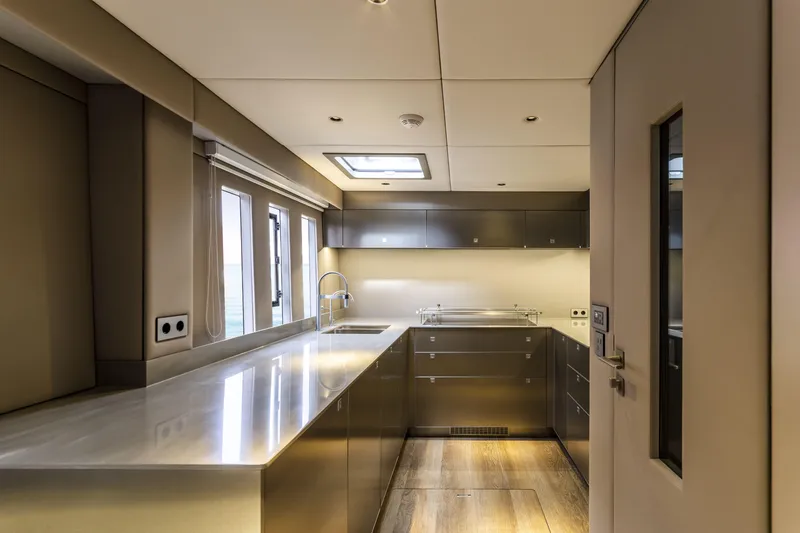 Slide: The Image of Modern kitchen interior on 2022 Sunreef 70 NAOMA yacht, featuring sleek cabinetry and stainless steel surfaces. - 10