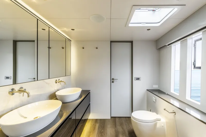 Slide: The Image of Luxurious bathroom on 2022 Sunreef 70 NAOMA yacht with dual sinks and ocean view. - 17