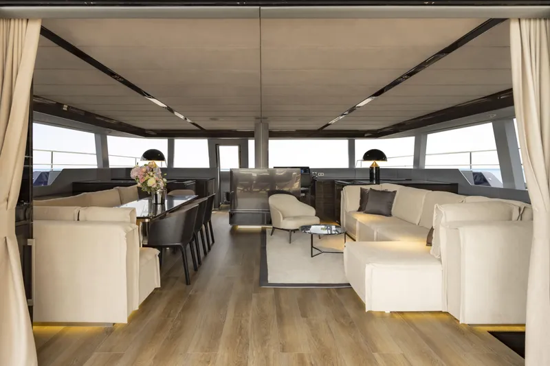 Slide: The Image of Luxurious interior of 2022 Sunreef 70 NAOMA yacht with elegant seating and dining area. - 3