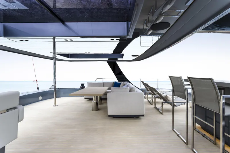 Slide: The Image of Luxurious Sunreef 70 NAOMA yacht deck with modern seating and ocean view, 2022 model. - 8