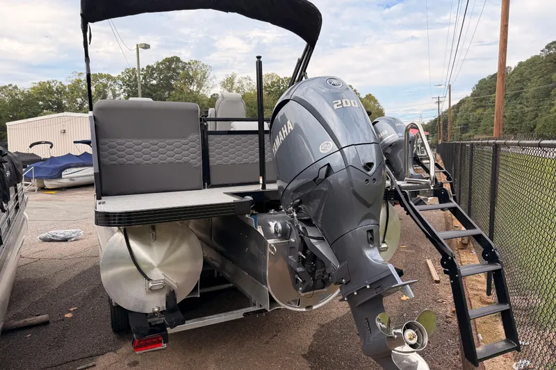 Slide: The Image of 2026 Veranda VR 235 RC pontoon boat with Yamaha 200 outboard motor, parked outdoors. - 4