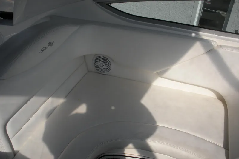 Slide: The Image of 2005 Sea Ray 280 Sundancer interior with white seating and speaker. - 16