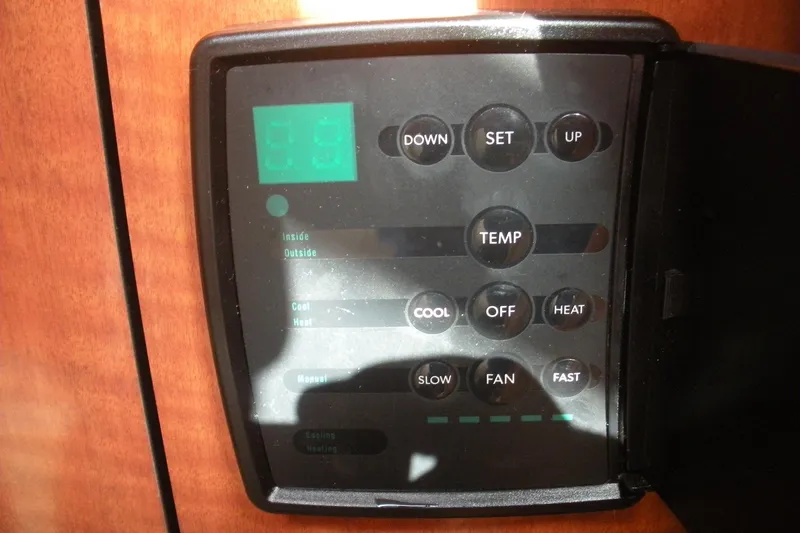 Slide: The Image of Control panel of a 2005 Sea Ray 280 Sundancer boat, featuring temperature settings. - 4