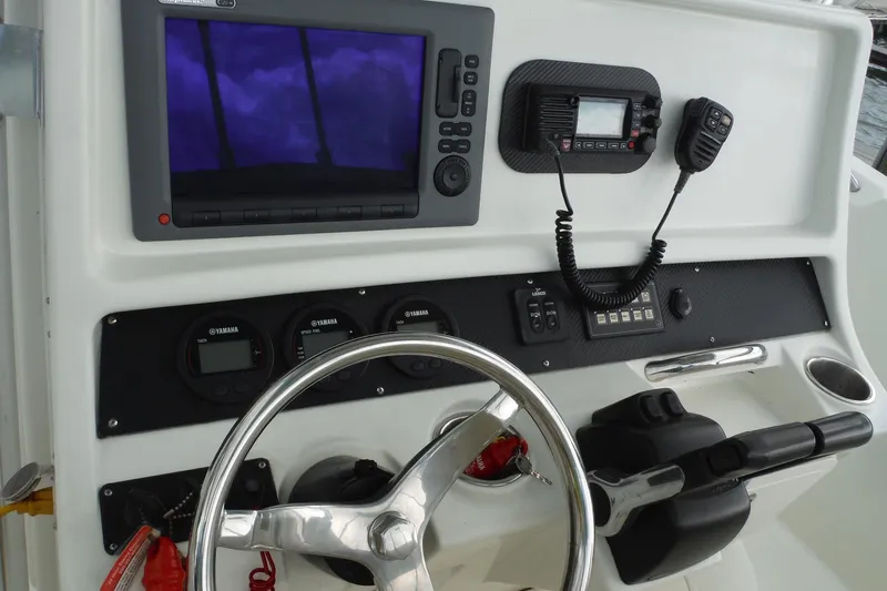 Slide: The Image of 2008 Sailfish 2660 CC boat dashboard with steering wheel, gauges, and navigation equipment. - 11