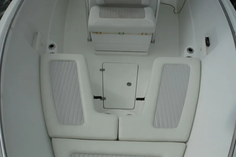 Slide: The Image of 2008 Sailfish 2660 CC boat interior with cushioned seating and storage compartment. - 14