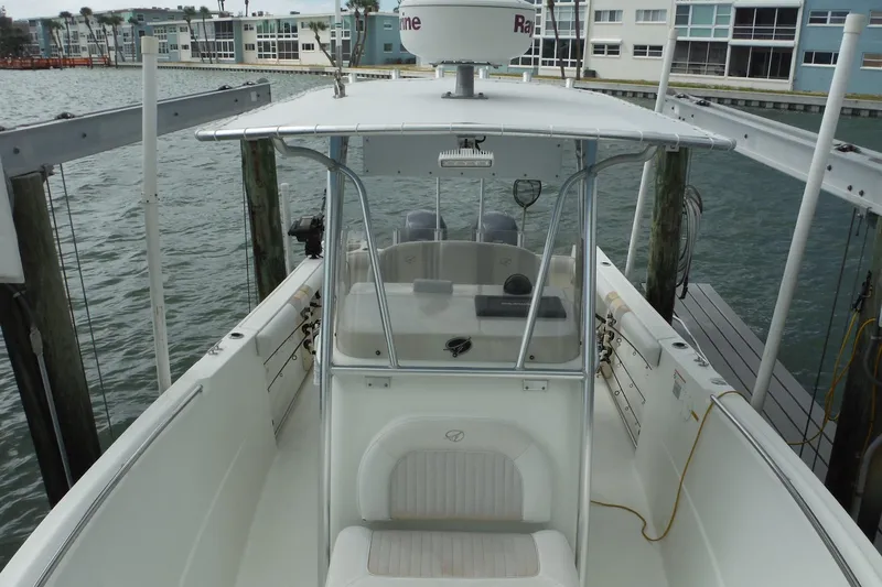 Slide: The Image of 2008 Sailfish 2660 CC boat docked, featuring center console and waterfront view. - 15